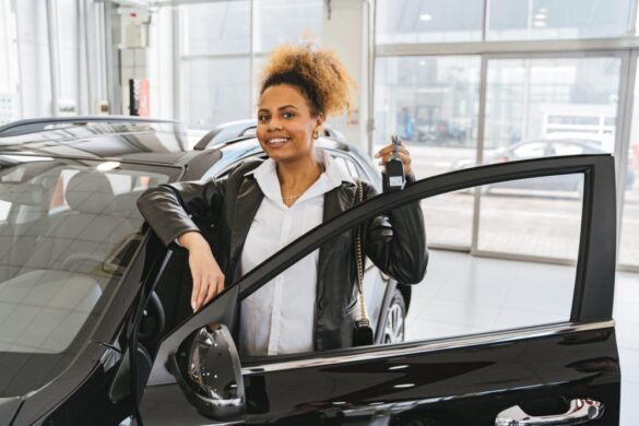 woman beside black car holding car keys