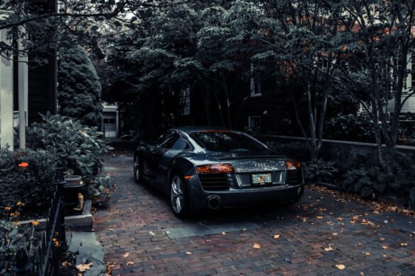 audi parked in a driveway near trees